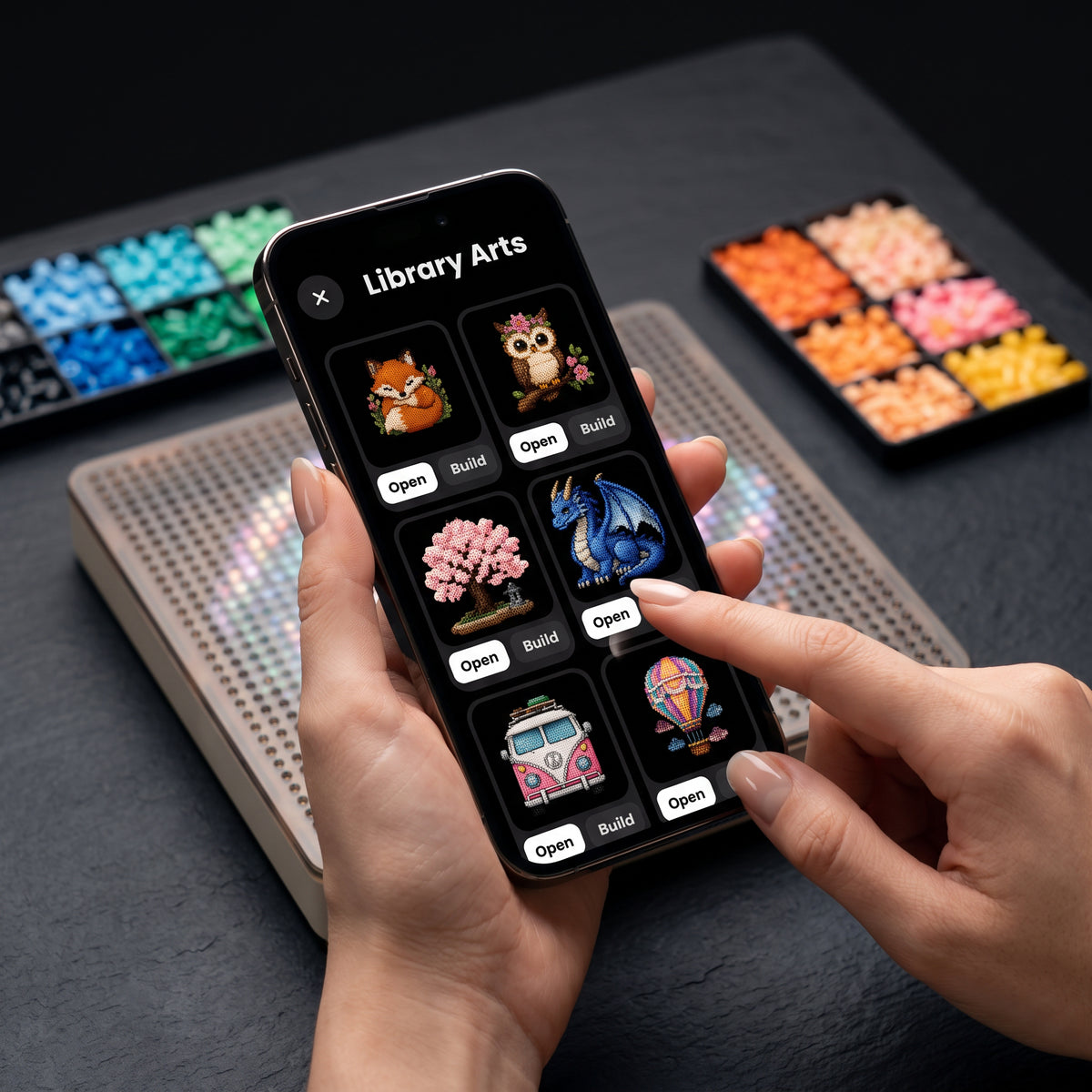The PixMaker pattern library on a phone beside the board